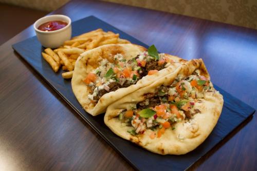 a plate of food with two tacos and french fries at Embassy Suites by Hilton Akron Canton Airport in North Canton