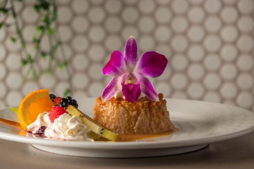 a dessert with a flower on top of it on a plate at Rincon Beach Resort in Rincon