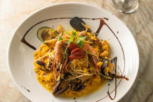 a white plate of food on a table at Rincon Beach Resort in Rincon