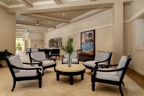 a waiting room with chairs and a table at Rincon Beach Resort in Rincon