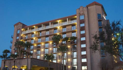 a large building with palm trees in front of it at Doubletree by Hilton McAllen in McAllen