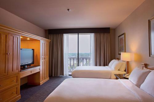 a hotel room with two beds and a television at Doubletree by Hilton McAllen in McAllen