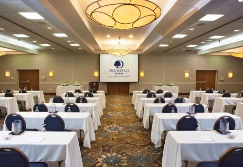 a banquet hall with white tables and chairs at DoubleTree by Hilton Hotel Oak Ridge - Knoxville in Oak Ridge
