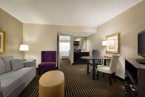 a living room with a couch and a table at Embassy Suites by Hilton Piscataway Somerset in Piscataway