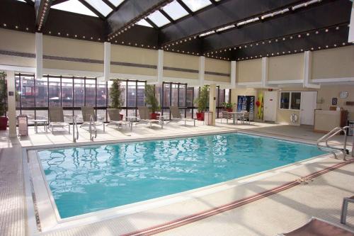 a large swimming pool with blue water in a building at Hilton St. Louis at the Ballpark in Saint Louis