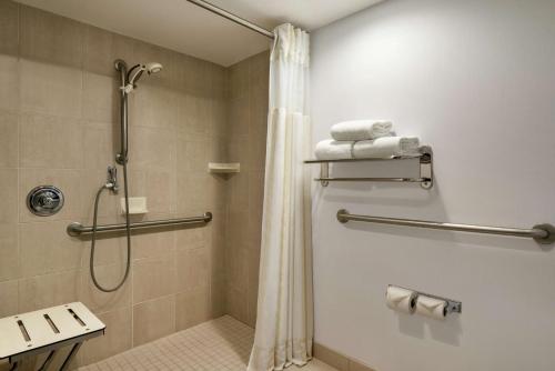 a bathroom with a shower with a shower curtain at Hilton Garden Inn Saskatoon Downtown in Saskatoon