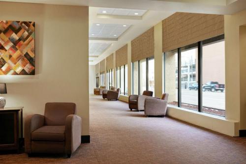 a waiting room with a row of chairs and windows at Hilton Garden Inn Saskatoon Downtown in Saskatoon