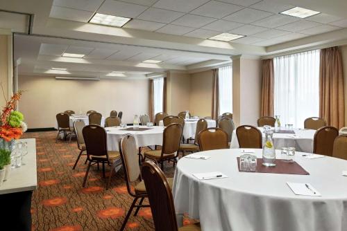 a conference room with white tables and chairs at Hilton Garden Inn Saskatoon Downtown in Saskatoon