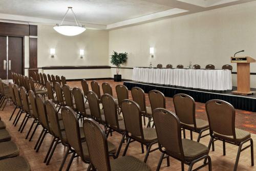 a row of chairs in a room with a podium at Hilton Garden Inn Saskatoon Downtown in Saskatoon