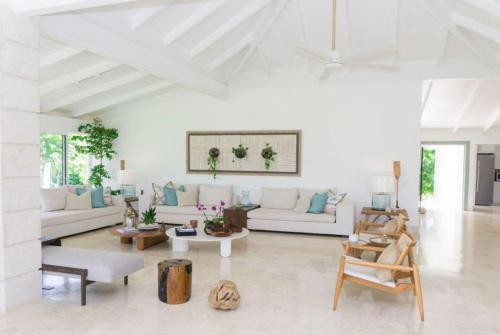 a living room with white furniture and a white ceiling at Sunny Vacation Villa No 92 in San Rafael del Yuma
