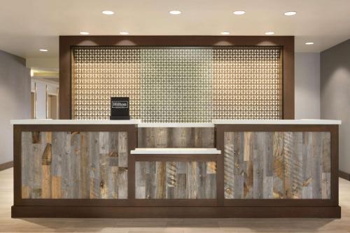 a lobby with a reception counter with a wall of tiles at Hilton Garden Inn Lompoc, Ca in Lompoc