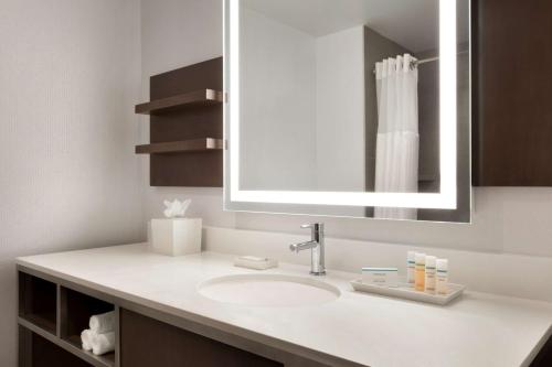 a bathroom with a sink and a mirror at Hilton Garden Inn Lompoc, Ca in Lompoc