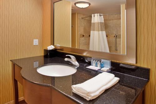 a bathroom with a sink and a mirror and a shower at Hampton Inn & Suites Aberdeen in Aberdeen