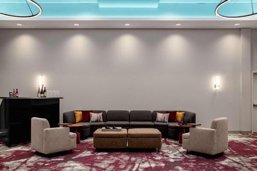 a living room with a couch and chairs and a tv at Hilton Garden Inn Mt. Juliet, TN in Mount Juliet