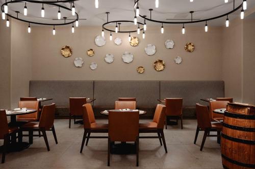 a dining room with tables and chairs and skulls on the wall at Hilton Garden Inn Mt. Juliet, TN in Mount Juliet