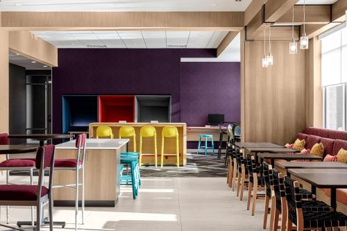 a dining room with tables and chairs and purple walls at Hilton Garden Inn Mt. Juliet, TN in Mount Juliet