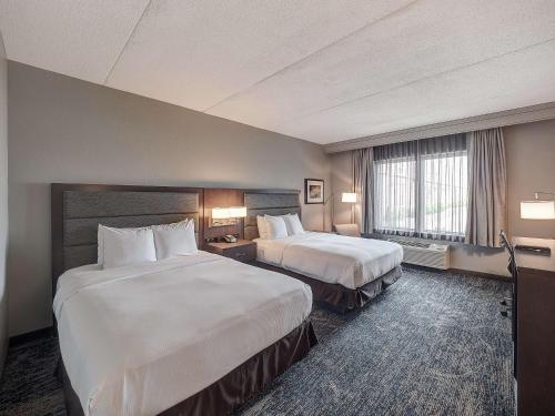 a hotel room with two beds and a window at DoubleTree by Hilton Bloomington in Bloomington