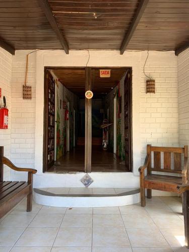 a front porch of a house with a bench at Pico da Tribo Pousada in Imbituba