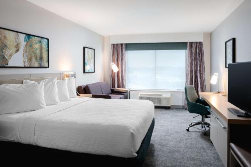 a hotel room with a bed and a desk at Hilton Garden Inn Mt. Juliet, TN in Mount Juliet