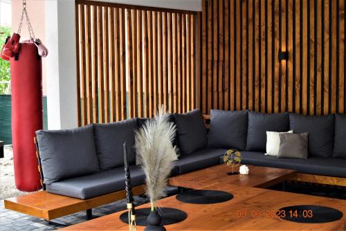 a living room with a blue couch and a table at Chalupa Martinček in Terchová