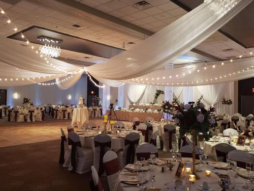 a banquet hall with white tables and chairs and lights at DoubleTree by Hilton Bloomington in Bloomington