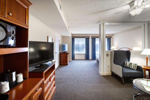 a hotel room with a television and a living room at Hilton Garden Inn Wooster in Wooster