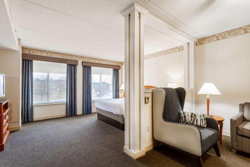 a hotel room with a bed and a chair at Hilton Garden Inn Wooster in Wooster