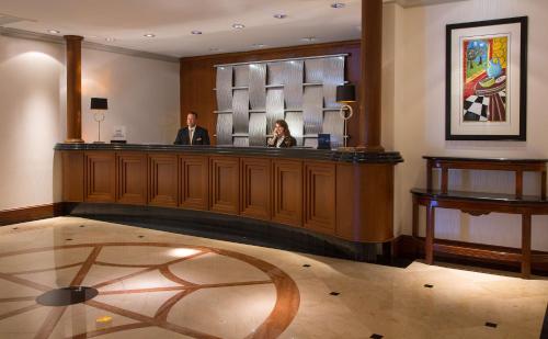 a man and a woman standing at a bar at Hilton Chicago/Northbrook in Northbrook