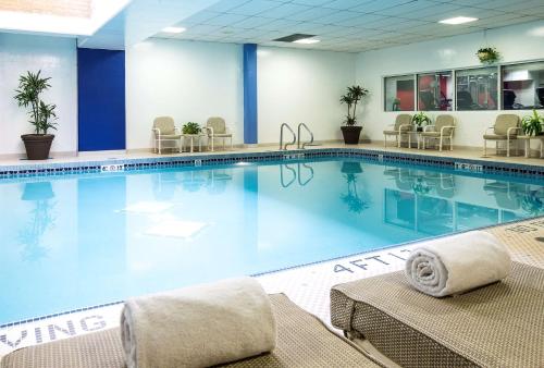 a pool in a hotel room with tables and chairs at Hilton Chicago/Northbrook in Northbrook