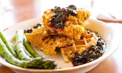 a plate of food with waffles and green beans at Hilton Chicago/Northbrook in Northbrook