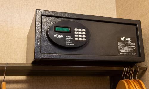a remote control sitting on top of a shelf at Hilton Chicago/Northbrook in Northbrook
