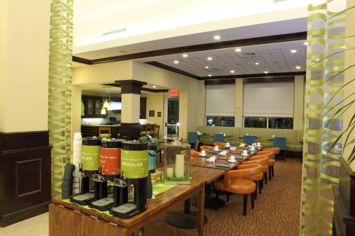 a large room with a long table and chairs at Hilton Garden Inn Frederick in Frederick