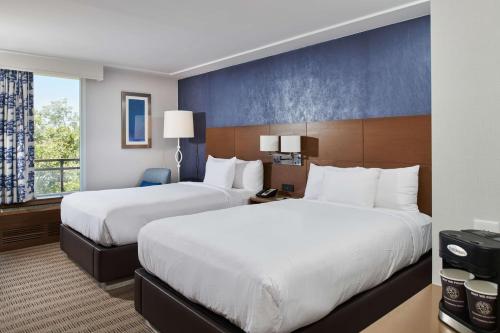a hotel room with two beds and a window at DoubleTree by Hilton Torrance - South Bay in Torrance