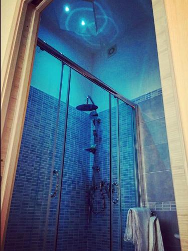 a bathroom with a shower with a glass door at B&B Crystal in Messina