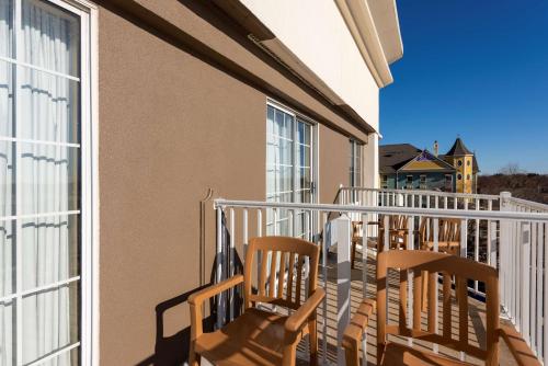 a balcony with two chairs and a building at Hampton Inn Holland in Holland