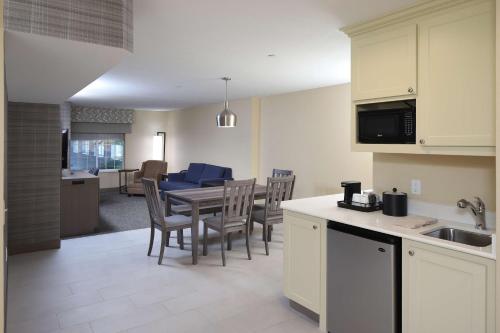 a kitchen and dining room with a table and chairs at Hampton Inn Holland in Holland