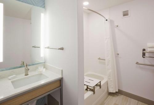 a white bathroom with a sink and a shower at Hilton Garden Inn Minneapolis Eagan in Eagan