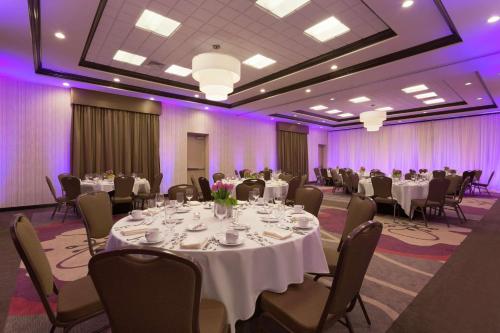 a banquet room with tables and chairs and purple lighting at Hilton Garden Inn Pittsburgh Airport South-Robinson Mall in Robinson Township