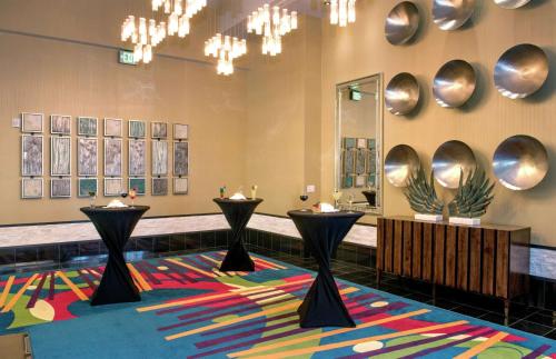 a lobby with two tables on a colorful rug at Hilton Garden Inn Raleigh/Crabtree Valley in Raleigh