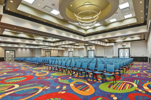a large room with blue chairs and a large carpet at Hilton Garden Inn Raleigh/Crabtree Valley in Raleigh