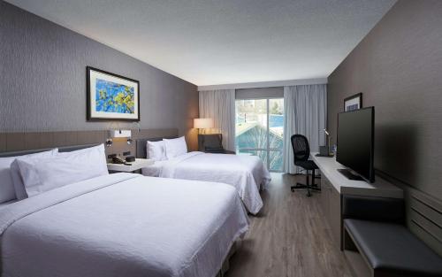 a hotel room with two beds and a flat screen tv at Hilton Garden Inn St. John's Newfoundland, Canada in St. John's