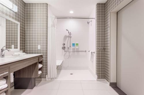 a bathroom with a shower and a sink at Home 2 Suites By Hilton Indianapolis Northwest in Indianapolis