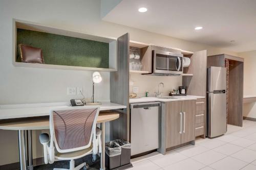 a kitchen with a sink and a counter top at Home 2 Suites By Hilton Indianapolis Northwest in Indianapolis