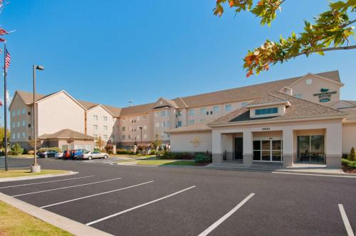 a parking lot in front of a hotel at Homewood Suites by Hilton Tulsa-South in Broken Arrow