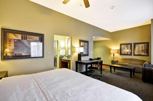 a hotel room with a bed and a desk at Homewood Suites by Hilton Tulsa-South in Broken Arrow