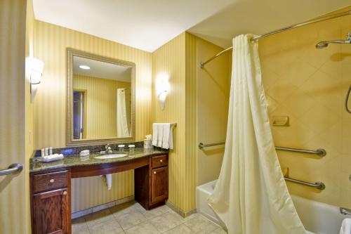 a bathroom with a shower and a sink and a tub at Homewood Suites by Hilton Tulsa-South in Broken Arrow