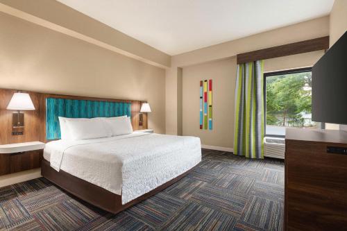 a hotel room with a bed and a window at Hampton Inn Atlanta-Stone Mountain in Stone Mountain