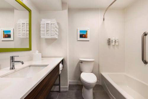 a bathroom with a toilet and a sink and a tub at Hampton Inn Atlanta-Stone Mountain in Stone Mountain