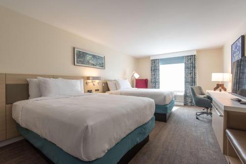 a hotel room with two beds and a desk at Hilton Garden Inn Calabasas in Calabasas