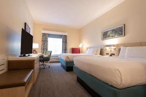 a hotel room with two beds and a television at Hilton Garden Inn Calabasas in Calabasas